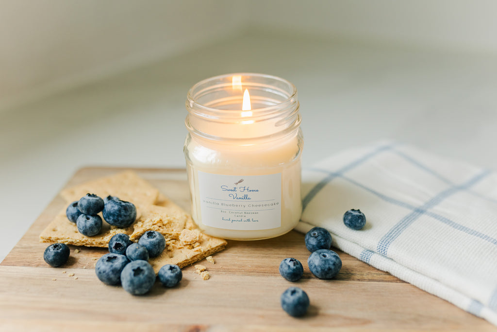 candle with blueberries and graham crackers around 